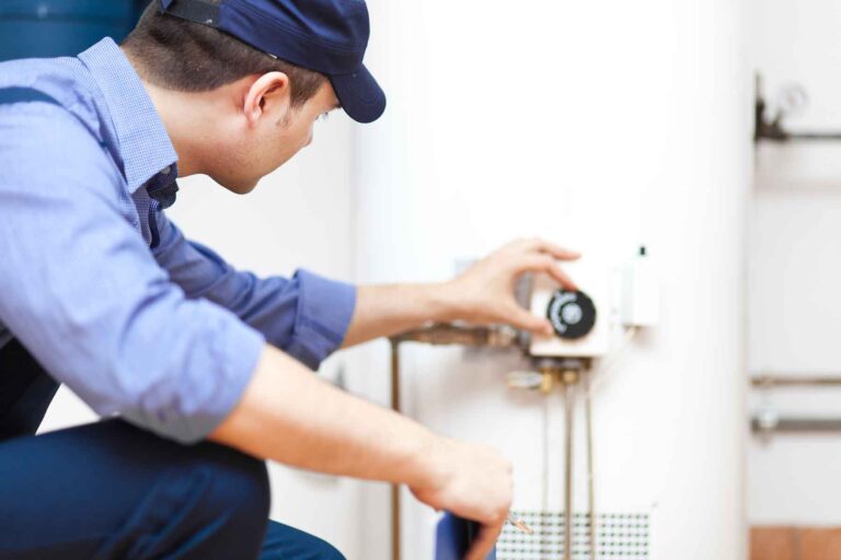 Contractor adjusting a water heater